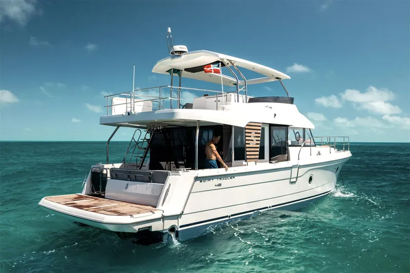 Yacht Photos Pics Manufacturer Provided Image: 2026 Beneteau Swift Trawler 48 cruising on clear blue ocean waters.