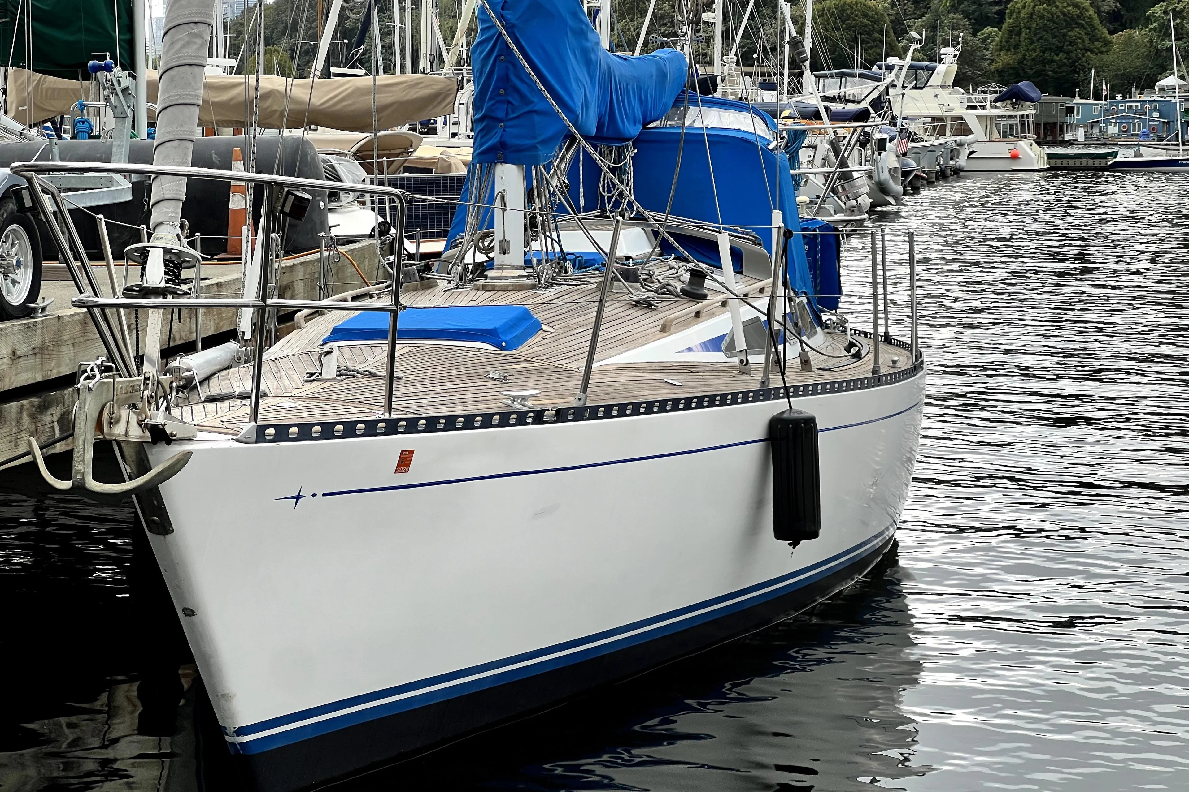 1983 CT 38 Warwick sailboat docked at marina, featuring sleek design and blue accents.