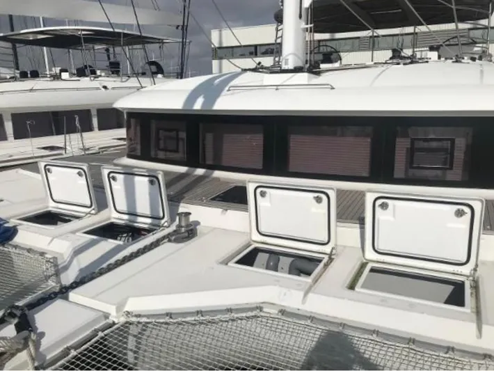 Sunset O Yacht Photos Pics 2019 Lagoon 620 catamaran with open hatches, showcasing modern design and spacious deck.