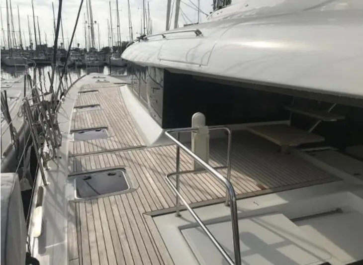 Sunset O Yacht Photos Pics 2019 Lagoon 620 yacht docked, showcasing spacious deck and sleek design.