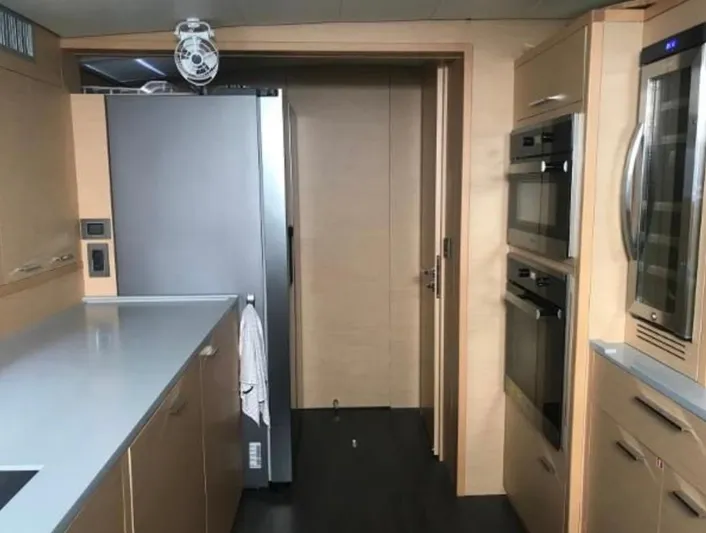 Sunset O Yacht Photos Pics Modern kitchen interior on a 2019 Lagoon 620 yacht, featuring sleek appliances and cabinetry.