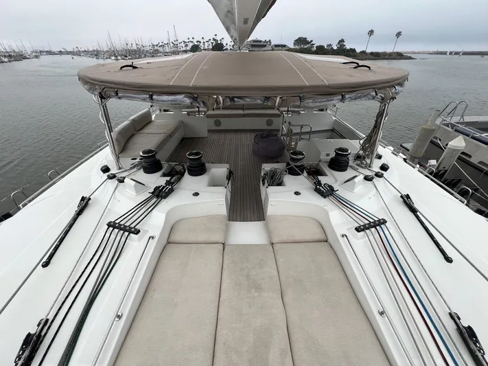Sunset O Yacht Photos Pics 2019 Lagoon 620 yacht deck with seating, winches, and ropes in a marina setting.