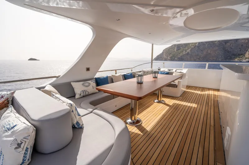 Yacht Photos Pics Luxurious 2024 Custom 27m Trawler yacht deck with elegant seating and ocean view.