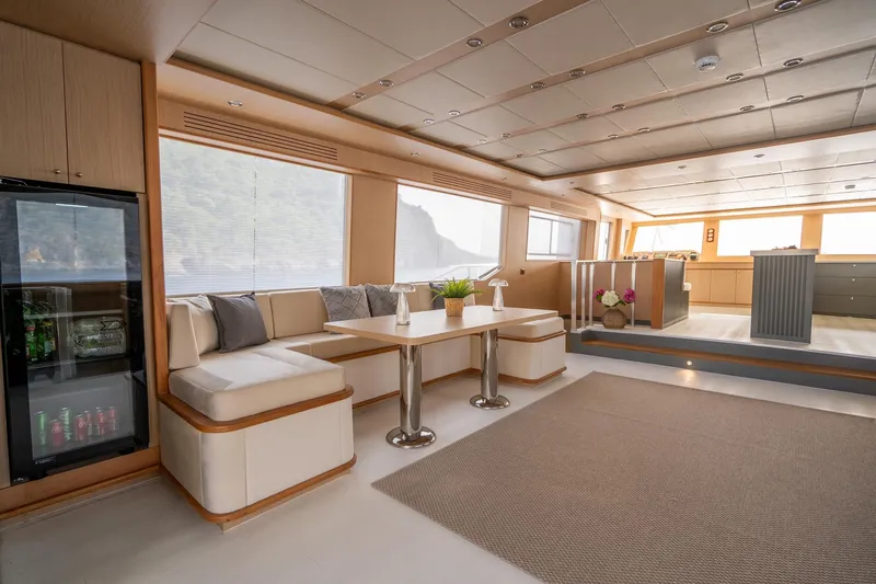  Yacht Photos Pics Luxurious interior of a 2024 Custom 27m Trawler with modern seating and large windows.
