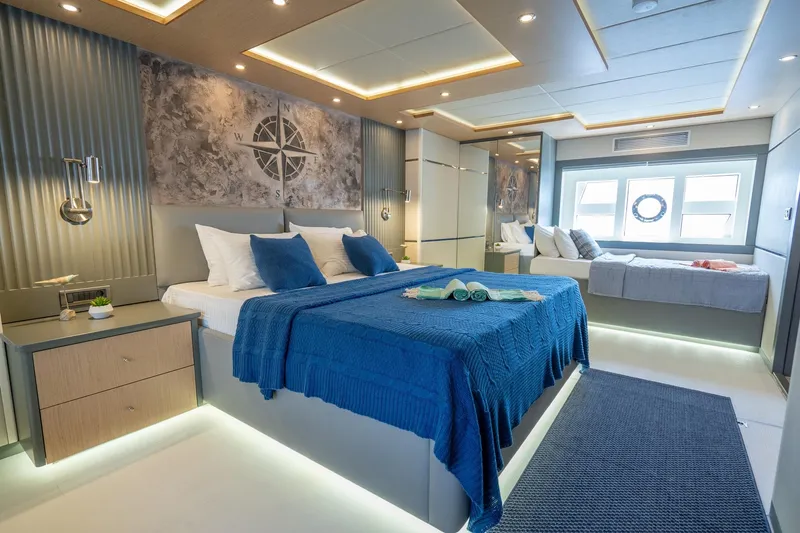  Yacht Photos Pics Luxurious 2024 Custom 27m Trawler bedroom with modern decor and blue accents.