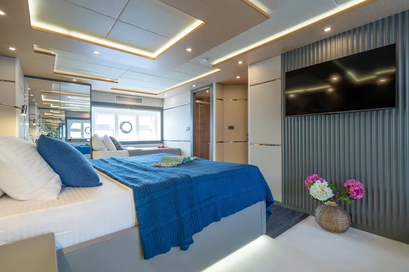  Yacht Photos Pics Luxurious 2024 Custom 27m Trawler bedroom with modern decor and large TV.