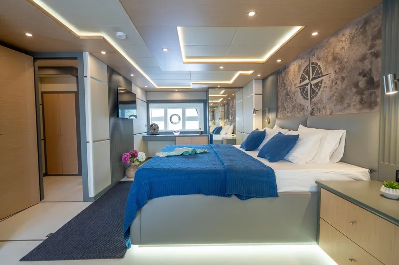  Yacht Photos Pics Luxurious bedroom interior of 2024 Custom 27m Trawler with modern decor and ambient lighting.