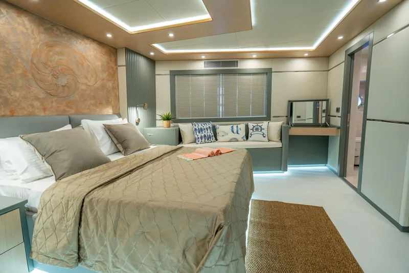  Yacht Photos Pics Luxurious bedroom interior of 2024 Custom 27m Trawler with modern decor and ambient lighting.