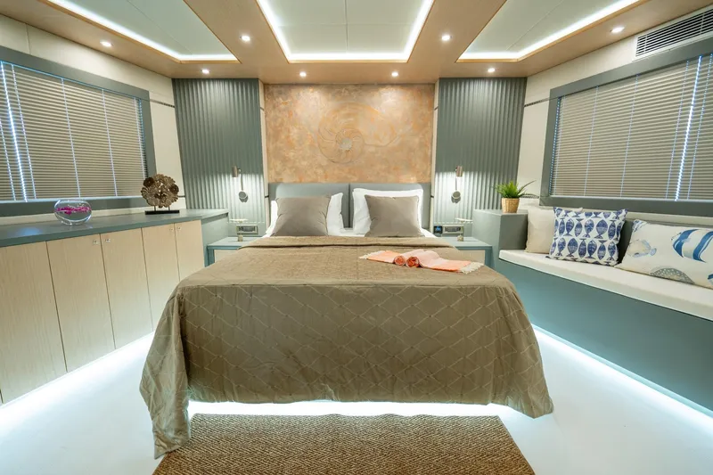  Yacht Photos Pics Luxurious bedroom interior of 2024 Custom 27m Trawler with modern decor and ambient lighting.