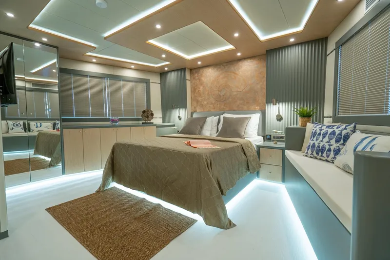  Yacht Photos Pics Luxurious bedroom interior on 2024 Custom 27m Trawler, featuring modern design and ambient lighting.