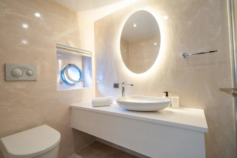  Yacht Photos Pics Luxurious bathroom on 2024 Custom 27m Trawler with modern fixtures and illuminated mirror.