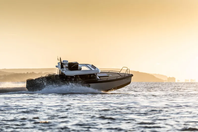  Yacht Photos Pics Arksen 30 boat cruising at sunset, 2025 model, on open water.