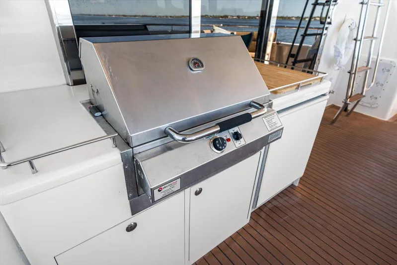 Octopi Yacht Photos Pics Outdoor grill on 1997 Lazzara EB 76 yacht deck with wooden flooring.