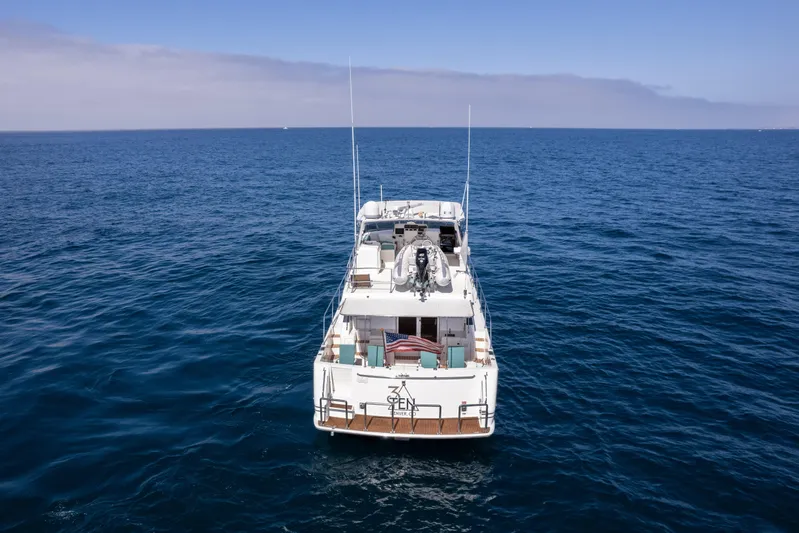 3ten Yacht Photos Pics 1997 West Bay Sonship yacht on open ocean, rear view, clear blue sky.