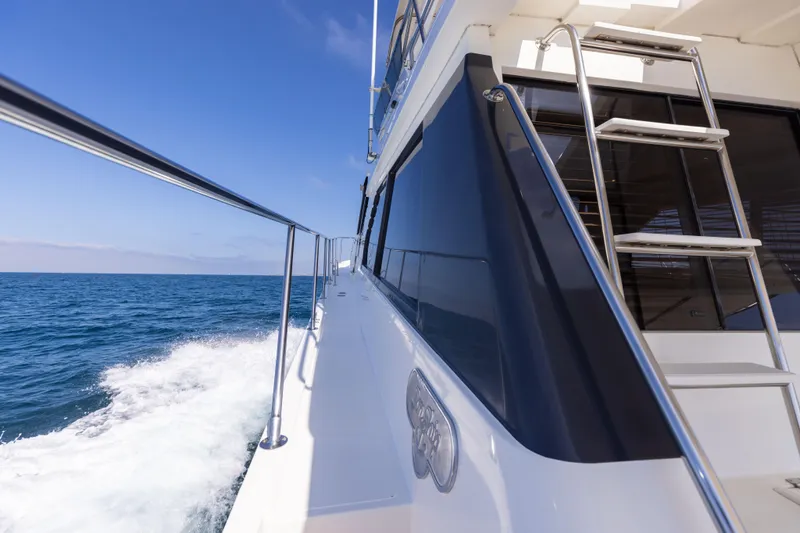 3ten Yacht Photos Pics 1997 West Bay Sonship yacht cruising on open sea under clear blue sky.