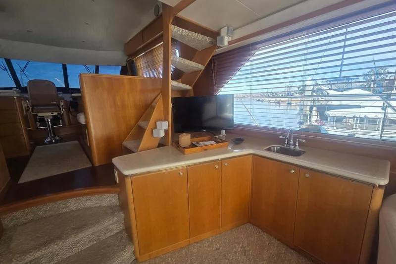 3ten Yacht Photos Pics Luxurious 1997 West Bay Sonship yacht interior with wooden cabinetry and marina view.