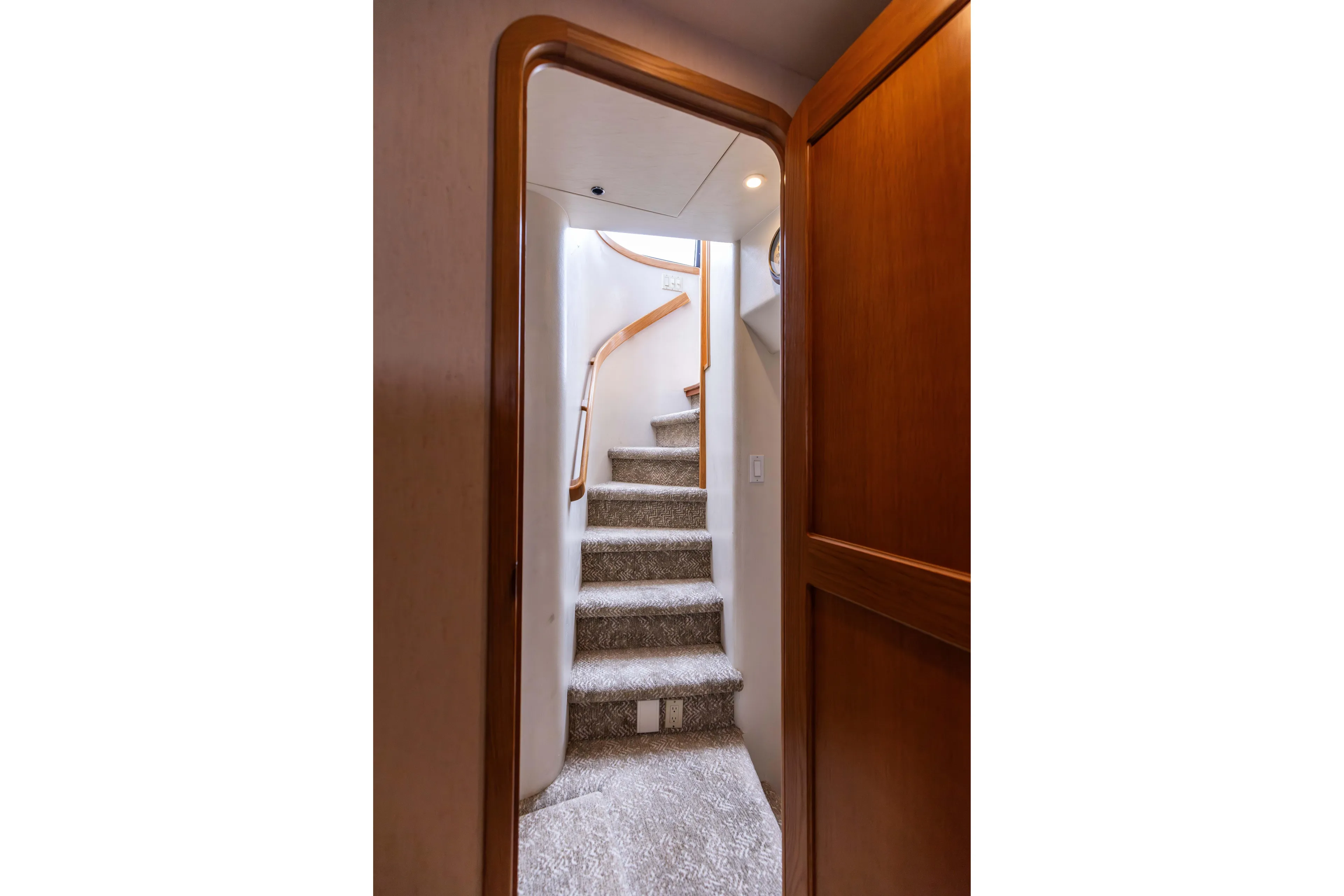 3ten Yacht Photos Pics Staircase inside 1997 West Bay Sonship yacht with wooden accents and carpeted steps.
