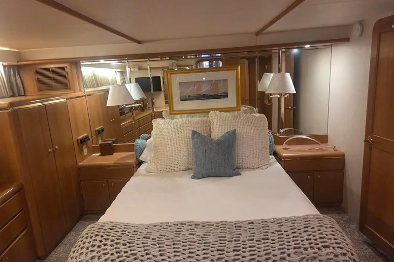 3ten Yacht Photos Pics Luxurious 1997 West Bay Sonship yacht bedroom with elegant wood furnishings and cozy bedding.