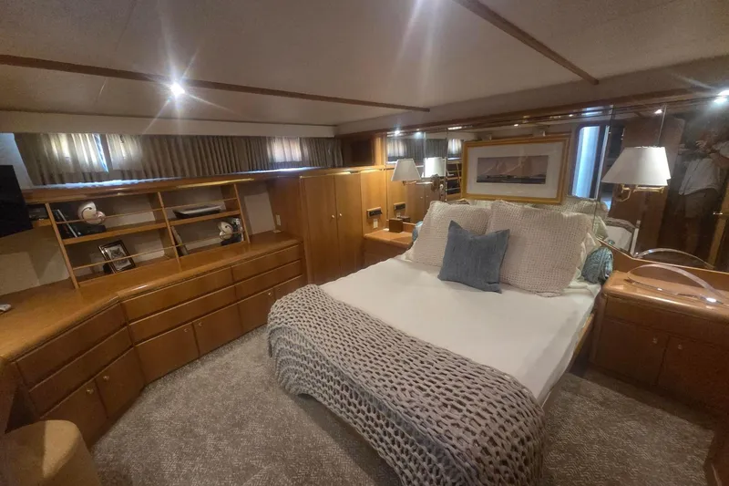 3ten Yacht Photos Pics Luxurious 1997 West Bay Sonship yacht bedroom with elegant wood furnishings and cozy bedding.