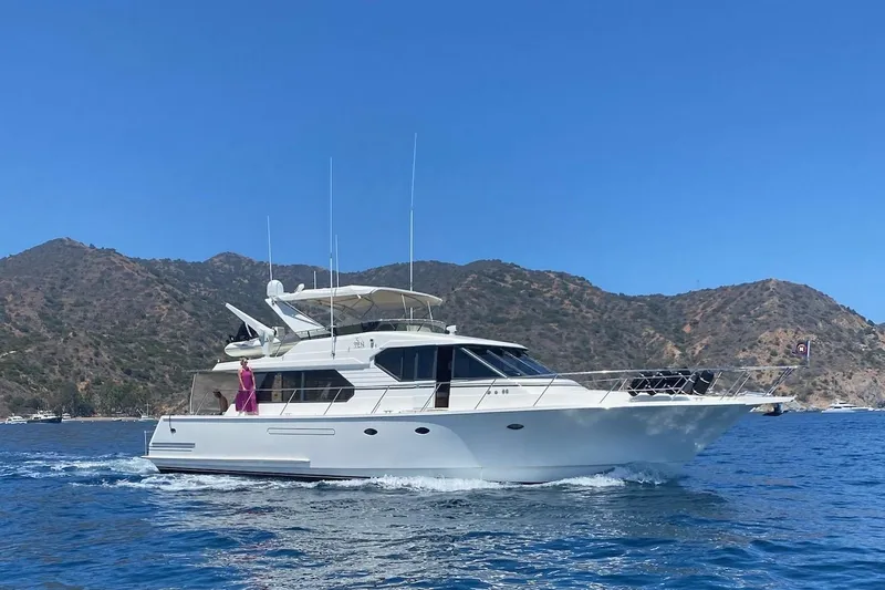 3ten Yacht Photos Pics 1997 West Bay Sonship yacht cruising near scenic coastal mountains.