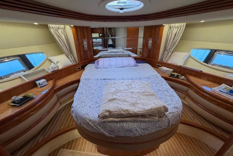  Yacht Photos Pics Luxurious bedroom interior of 2007 Azimut 68 EVO yacht with elegant wood finishes.