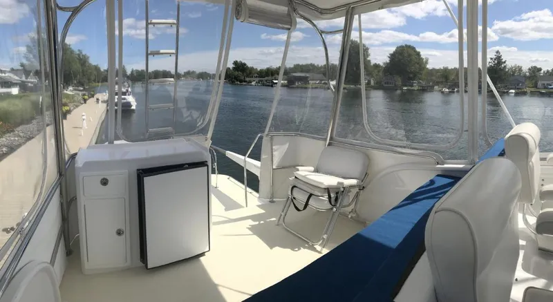  Yacht Photos Pics 2007 Duffy Aft Cabin boat interior with seating, fridge, and river view.