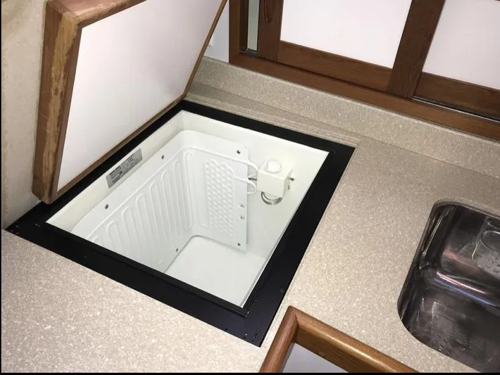  Yacht Photos Pics Open storage compartment in 2007 Duffy Aft Cabin boat kitchen area.