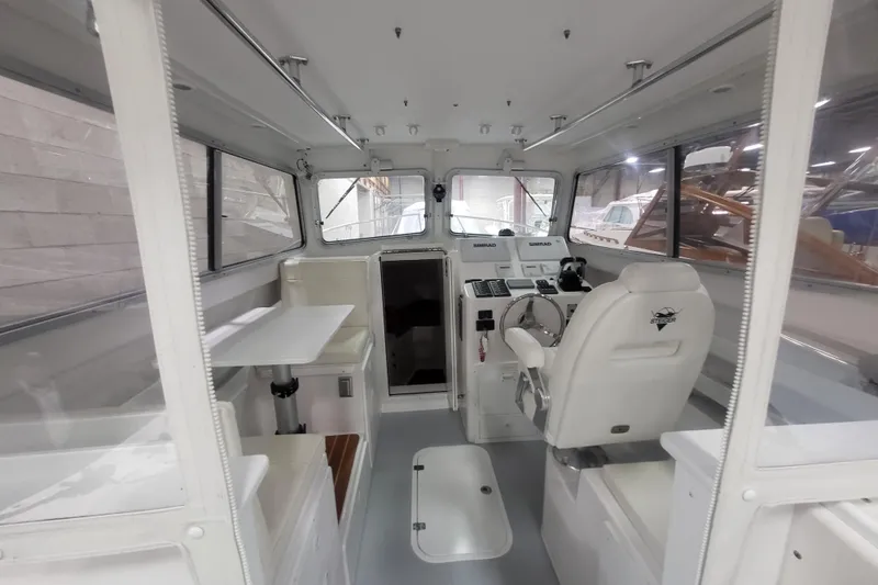 Yacht Photos Pics 2020 Steiger Craft 31 Miami boat interior with helm, seating, and navigation equipment.