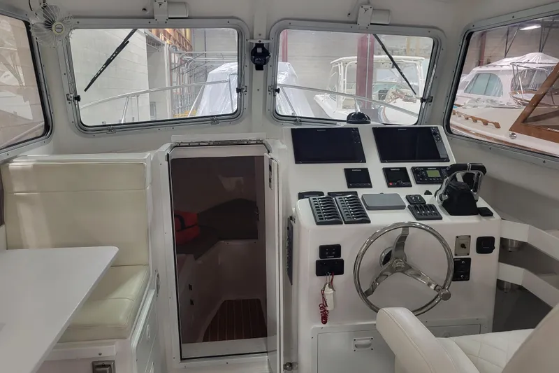  Yacht Photos Pics 2020 Steiger Craft 31 Miami boat interior with helm, seating, and navigation equipment.