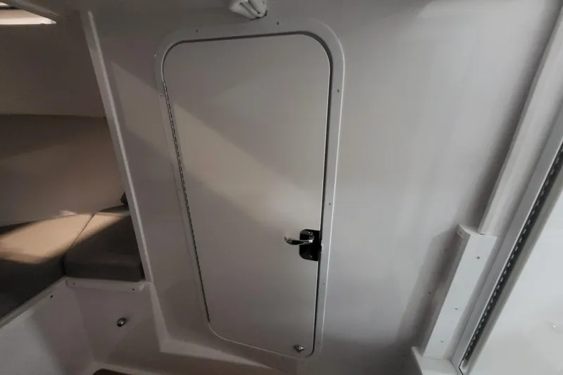  Yacht Photos Pics 2020 Steiger Craft 31 Miami cabin interior with closed door and seating area.