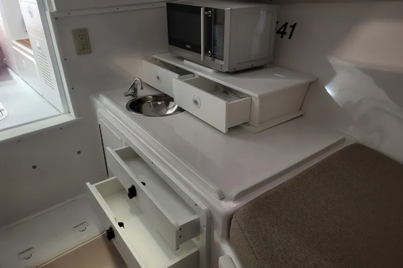  Yacht Photos Pics 2020 Steiger Craft 31 Miami interior with microwave, sink, and storage drawers.