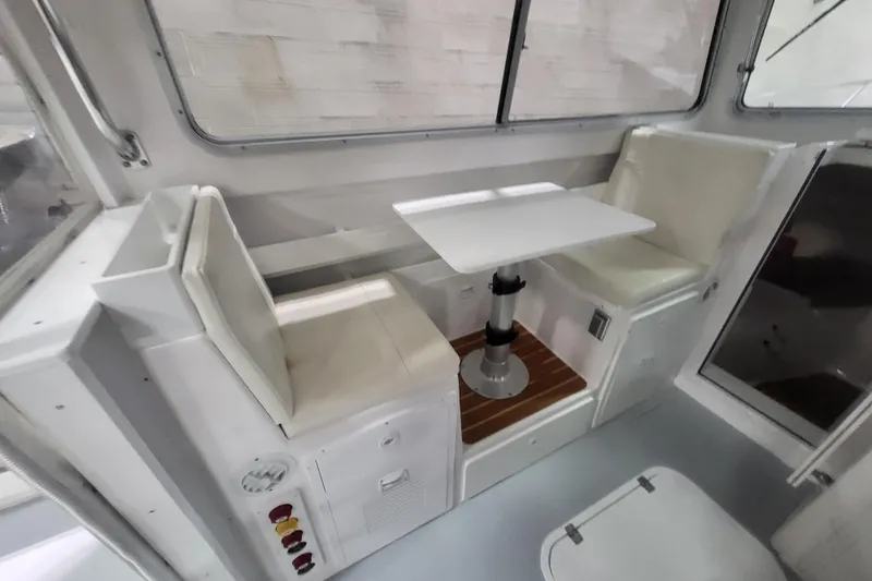  Yacht Photos Pics Interior of 2020 Steiger Craft 31 Miami boat with seating and table.