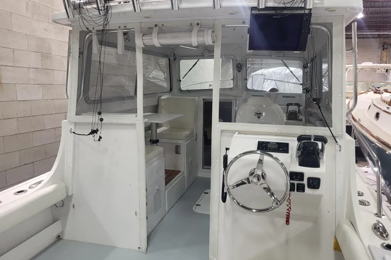  Yacht Photos Pics 2020 Steiger Craft 31 Miami boat interior with steering wheel and control panel.