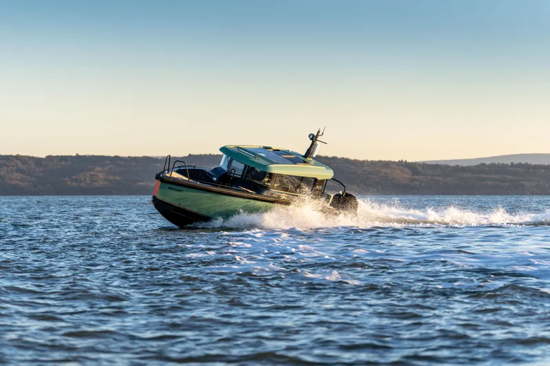  Yacht Photos Pics 2025 Arksen 28 boat cruising on open water at sunset.