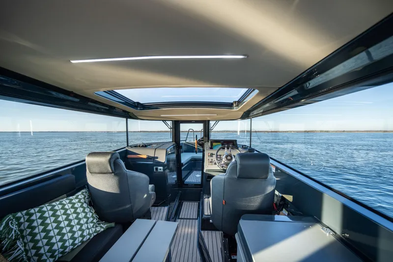  Yacht Photos Pics Interior of 2025 Arksen 28 boat with panoramic windows and modern seating.