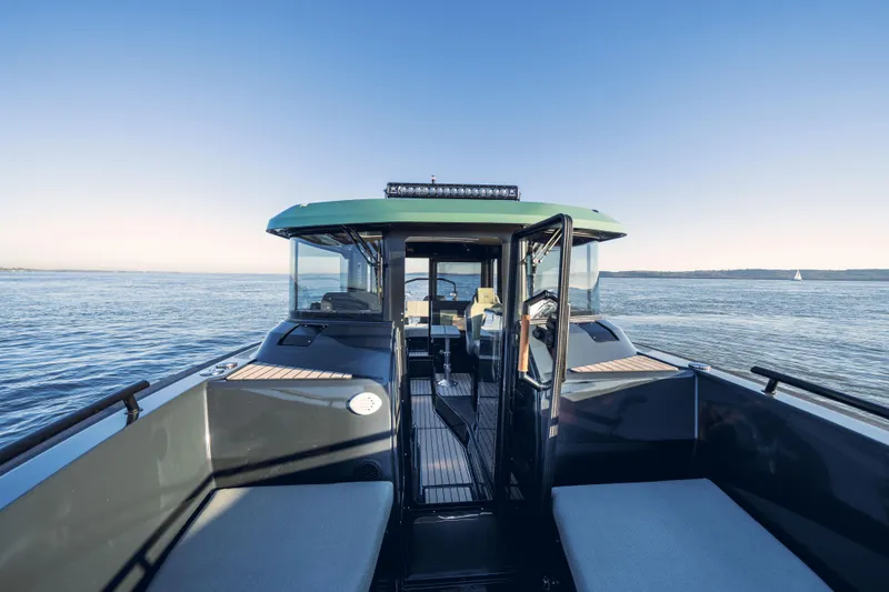  Yacht Photos Pics 2025 Arksen 28 boat on calm waters with clear blue sky.