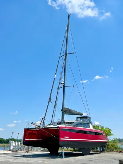 Rogue Yacht Photos Pics Red Privilege 510 catamaran on land, clear blue sky, 2021 model.
