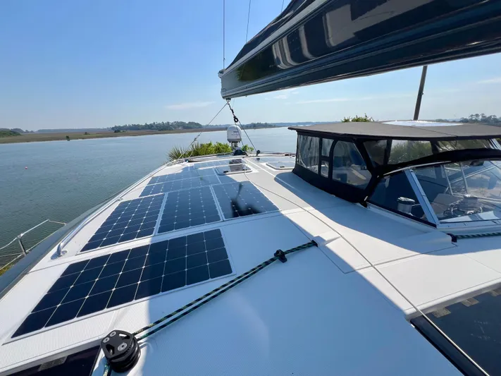 Rogue Yacht Photos Pics Luxury Privilege 510 yacht with solar panels, sailing on a serene river, 2021 model.