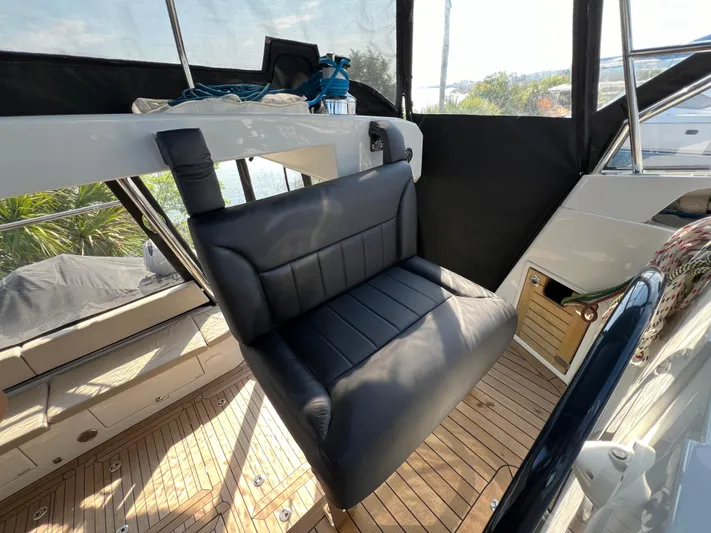 Rogue Yacht Photos Pics Luxurious interior of 2021 Privilege 510 yacht with black leather seating and wooden flooring.