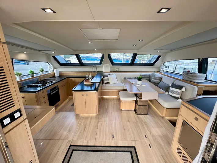 Rogue Yacht Photos Pics Luxurious interior of 2021 Privilege 510 yacht with modern kitchen and seating area.