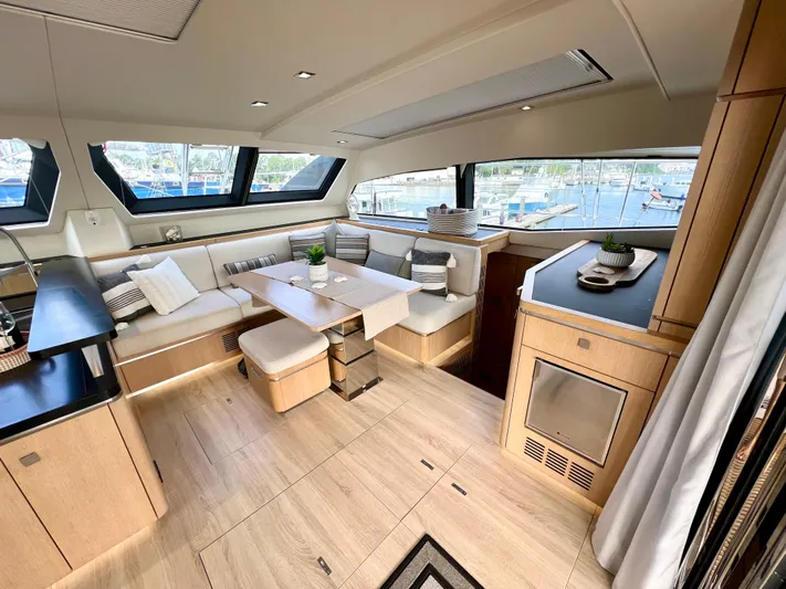 Rogue Yacht Photos Pics Luxurious interior of 2021 Privilege 510 yacht with modern dining area and panoramic windows.