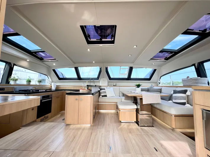 Rogue Yacht Photos Pics Luxurious interior of 2021 Privilege 510 yacht with modern kitchen and seating area.