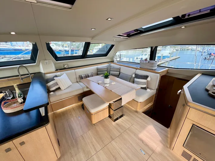 Rogue Yacht Photos Pics Luxurious interior of 2021 Privilege 510 yacht with elegant seating and panoramic windows.