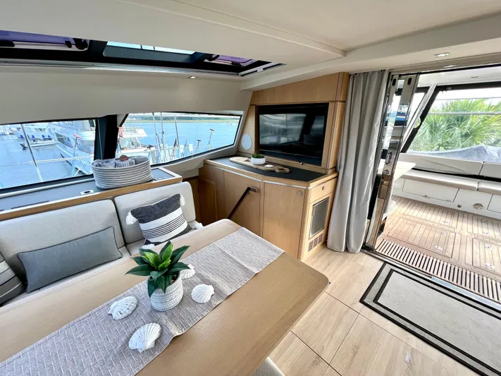 Rogue Yacht Photos Pics Luxurious interior of 2021 Privilege 510 yacht with elegant dining area and scenic views.