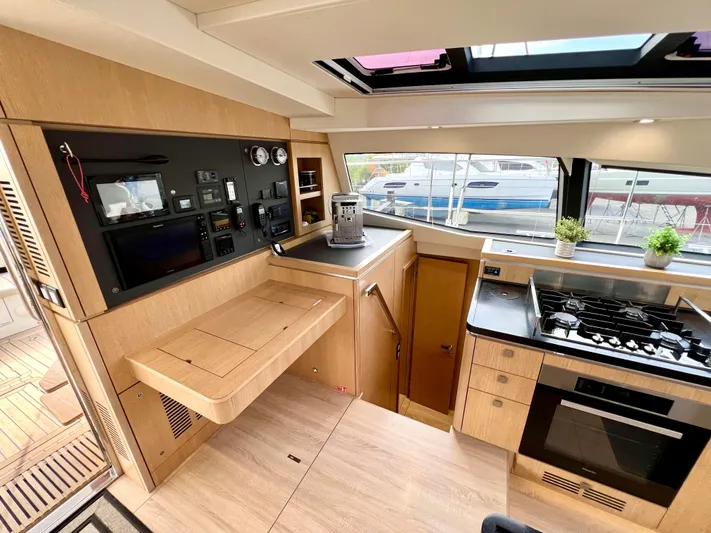 Rogue Yacht Photos Pics Modern kitchen interior of 2021 Privilege 510 yacht with stove, oven, and navigation controls.