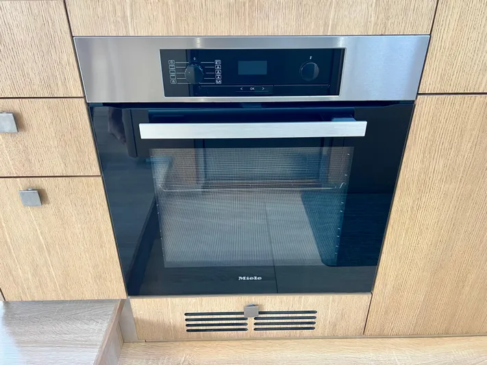 Rogue Yacht Photos Pics Modern built-in oven with digital controls, stainless steel finish, and wooden cabinetry. Privilege 510, 2021 model.