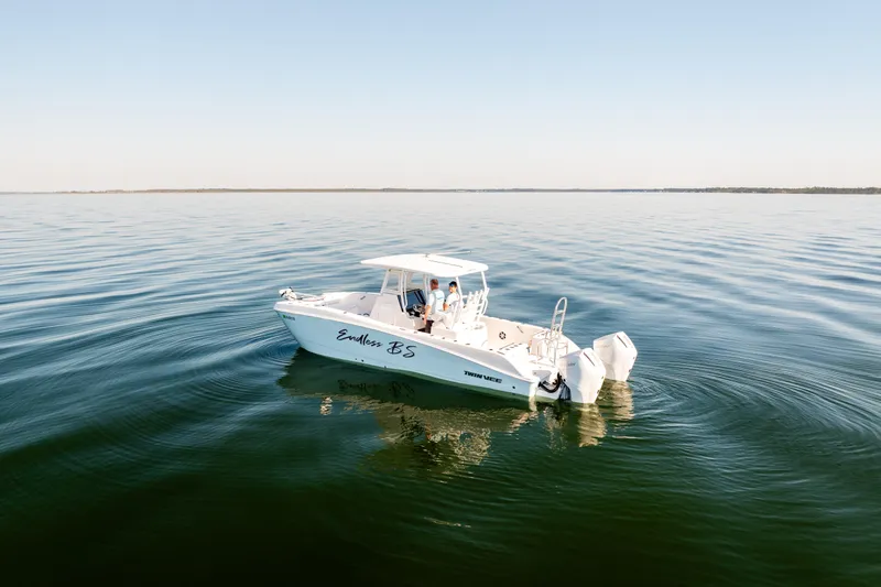Endless Bs Yacht Photos Pics 2023 Twin Vee 260 GFX CC boat cruising on calm waters under clear sky.