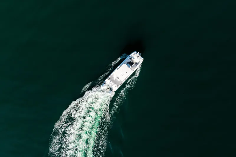 Endless Bs Yacht Photos Pics Aerial view of 2023 Twin Vee 260 GFX CC boat cruising on open water.