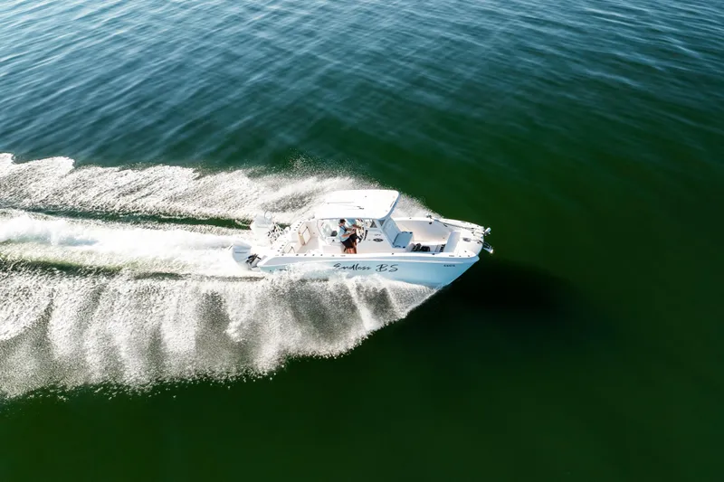 Endless Bs Yacht Photos Pics 2023 Twin Vee 260 GFX CC boat cruising on open water, creating a dynamic wake.