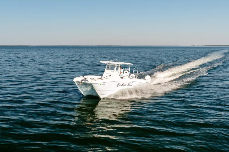Endless Bs Yacht Photos Pics 2023 Twin Vee 260 GFX CC boat cruising on open water under clear skies.